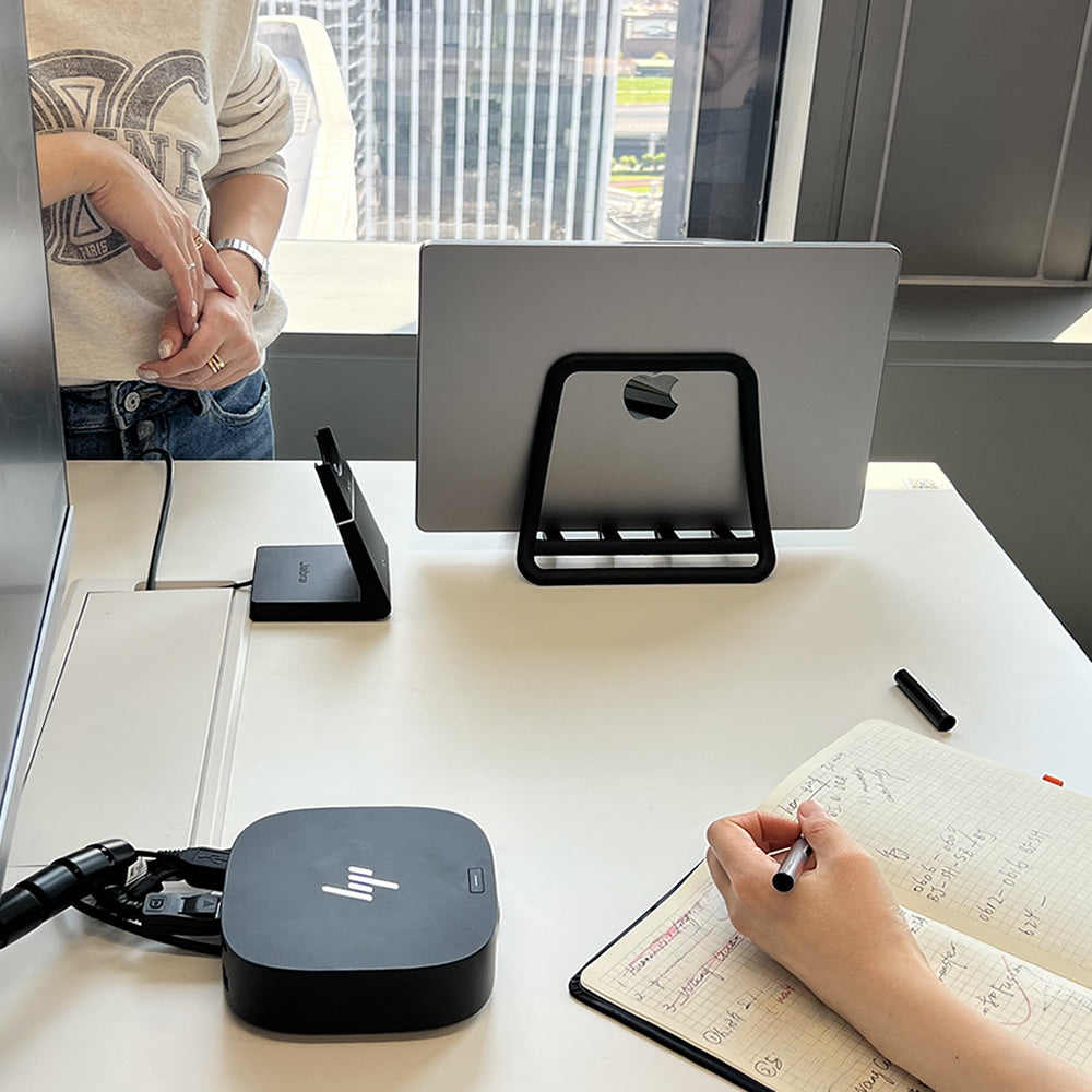 Nexstand K11 vertical stand on a professional office desk saving space